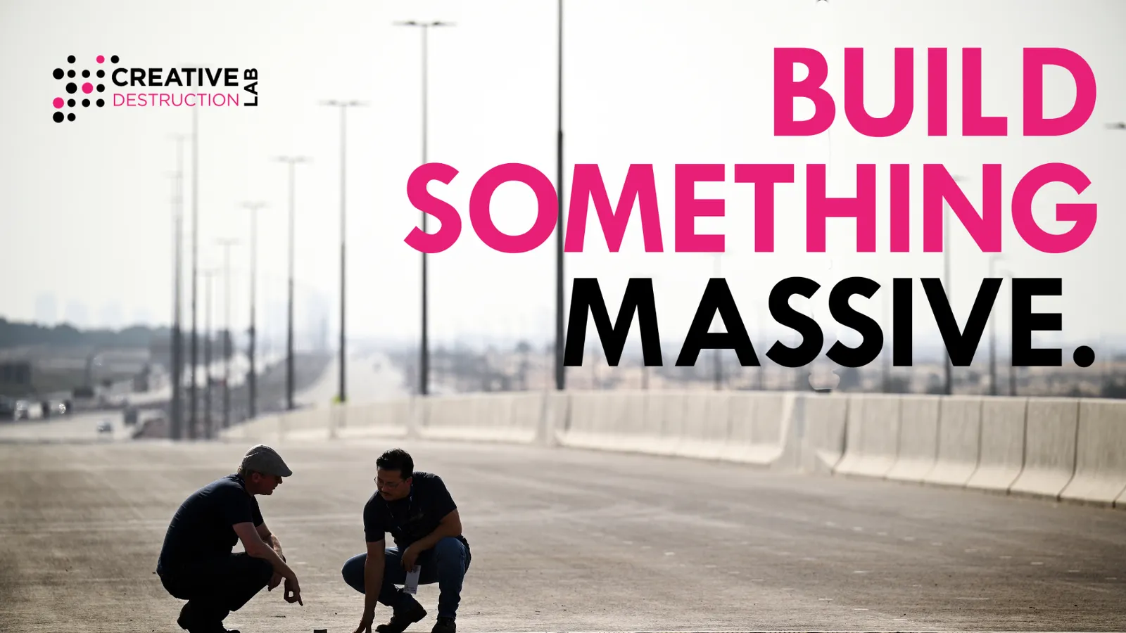 Two people crouch on a new, empty highway under the words “Build something massive”, Creative Destruction Lab’s programme image
